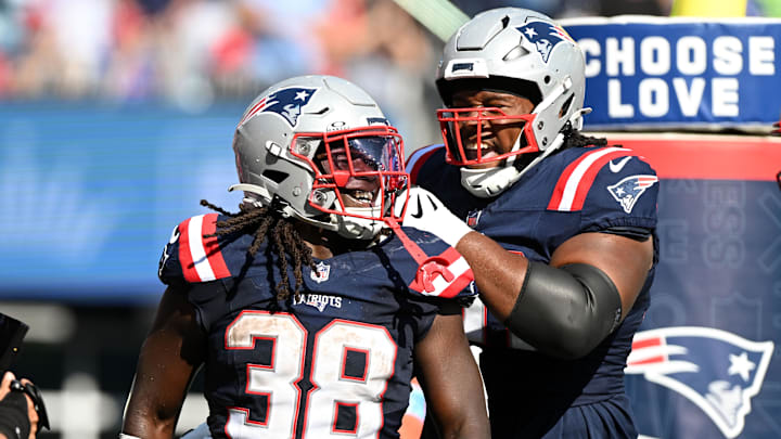 Sep 15, 2024; Foxborough, Massachusetts, USA;  New England Patriots running back Rhamondre Stevenson (38) celebrates with offensive tackle Caedan Wallace (70) after scoring a touchdown against the Seattle Seahawks during the second half at Gillette Stadium.
