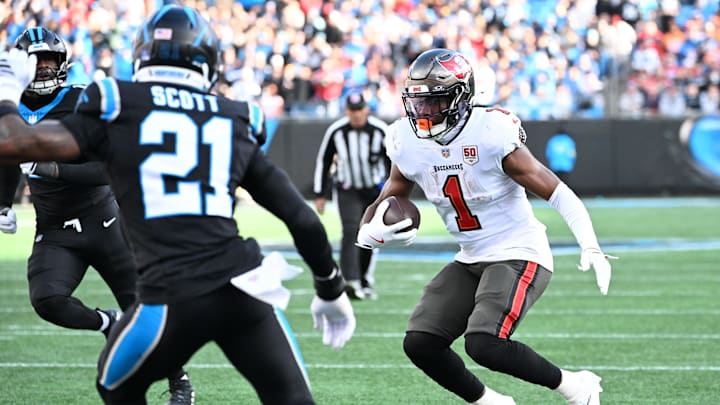 Dec 21, 2025; Charlotte, North Carolina, USA; Tampa Bay Buccaneers running back Rachaad White (1) with the ball in the third quarter as Carolina Panthers safety Nick Scott (21) defends at Bank of America Stadium. Mandatory Credit: Bob Donnan-Imagn Images