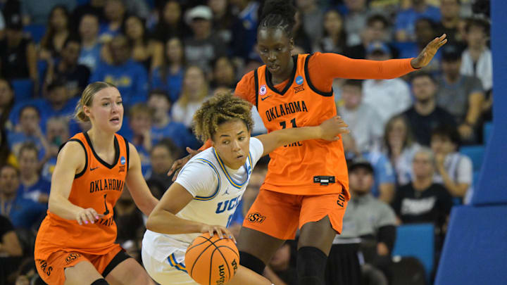 Mar 23, 2026; Los Angeles, CA, USA;  UCLA Bruins guard Kiki Rice (1) is defended by Oklahoma State Cowboys guard Amari Whiting (1) and forward Achol Akot (11) in the second half at Pauley Pavilion. Mandatory Credit: Jayne Kamin-Oncea-Imagn Images