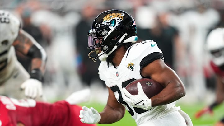 Nov 23, 2025; Glendale, Arizona, USA;  Jacksonville Jaguars running back Bhayshul Tuten (33) rushes during the fourth quarter against the Arizona Cardinals at State Farm Stadium. 