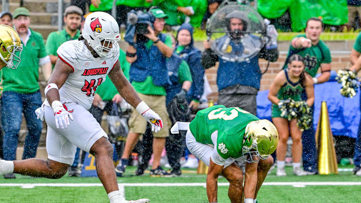 Sep 28, 2024; South Bend, Indiana, USA; Notre Dame Fighting Irish safety Kennedy Urlacher (23) recovers a mis-snapped punt against the Louisville Cardinals in the first quarter at Notre Dame Stadium. Mandatory Credit: Matt Cashore-Imagn Images