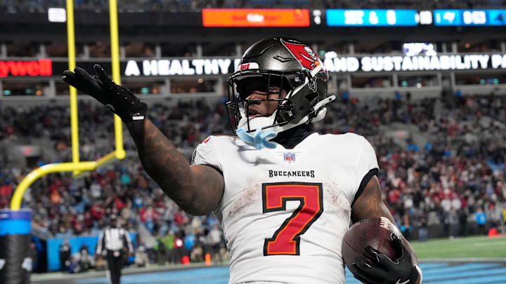 Dec 1, 2024; Charlotte, North Carolina, USA; Tampa Bay Buccaneers running back Bucky Irving (7) blows a kiss to the crowd after scoring a touchdown in the fourth quarter at Bank of America Stadium. Mandatory Credit: Bob Donnan-Imagn Images