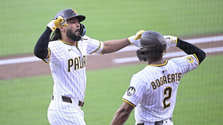 Sep 27, 2025; San Diego, California, USA; San Diego Padres right fielder Fernando Tatis Jr. (23) is congratulated by Luis Arraez (4) after hitting a solo home run during the first inning against the Arizona Diamondbacks at Petco Park. Mandatory Credit: Denis Poroy-Imagn Images