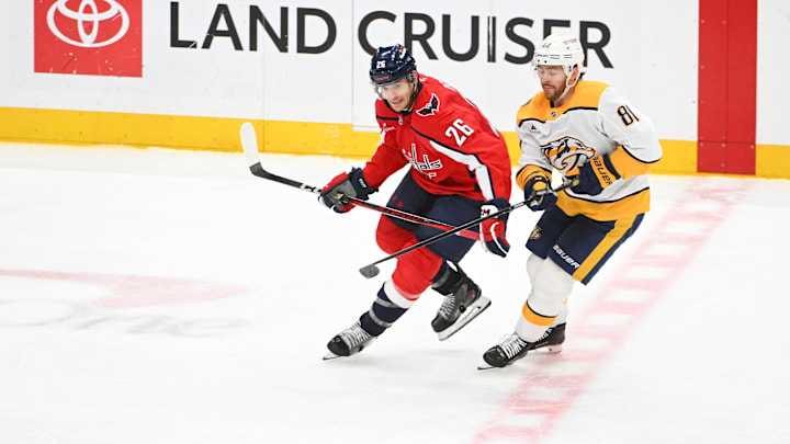 Feb 5, 2026; Washington, District of Columbia, USA; Washington Capitals center Nic Dowd (26) and Nashville Predators center Jonathan Marchessault (81) battle for the puck during the third period at Capital One Arena. Mandatory Credit: Brad Mills-Imagn Images