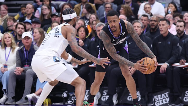 Feb 28, 2025; Salt Lake City, Utah, USA; Utah Jazz forward John Collins (20) holds the ball away from Minnesota Timberwolves guard Nickeil Alexander-Walker (9) during the second quarter at Delta Center. Mandatory Credit: Rob Gray-Imagn Images
