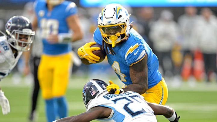 Nov 10, 2024; Inglewood, California, USA; Los Angeles Chargers running back Gus Edwards (4) carries the ball for a first down before he is stopped by Tennessee Titans cornerback Jarvis Brownlee Jr. (29) in the first half at SoFi Stadium. Mandatory Credit: Jayne Kamin-Oncea-Imagn Images Nov 10, 2024; Inglewood, California, USA; Los Angeles Chargers running back Gus Edwards (4) carries the ball for a first down before he is stopped by Tennessee Titans cornerback Jarvis Brownlee Jr. (29) in the first half at SoFi Stadium. Mandatory Credit: Jayne Kamin-Oncea-Imagn Images