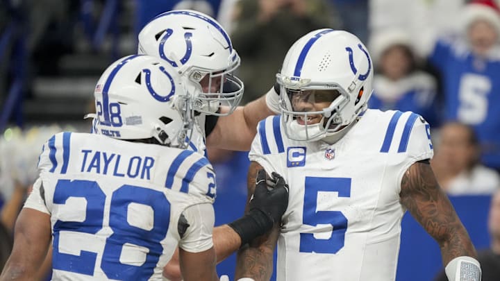 Dec 22, 2024; Indianapolis, Indiana, USA; Indianapolis Colts quarterback Anthony Richardson (5) celebrates with teammates after rushing for a touchdown during a game against the Tennessee Titans at Lucas Oil Stadium. 