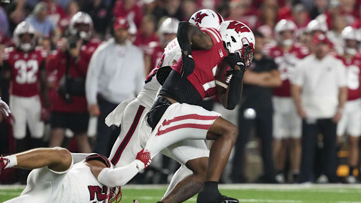 Aug 28, 2025; Madison, Wisconsin, USA;  Miami (OH) RedHawks linebacker Oscar McWood (23) tries to tackle Wisconsin Badgers running back Dilin Jones (7) during the third quarter at Camp Randall Stadium. Mandatory Credit: Jeff Hanisch-Imagn Images