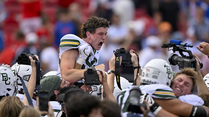 Sep 6, 2025; Dallas, Texas, USA; Baylor Bears place kicker Connor Hawkins (96) celebrates with his teammates after he makes a game winning field goal to defeat the SMU Mustangs during the second overtime at Gerald J. Ford Stadium. Mandatory Credit: Jerome Miron-Imagn Images Sep 6, 2025; Dallas, Texas, USA; Baylor Bears place kicker Connor Hawkins (96) celebrates with his teammates after he makes a game winning field goal to defeat the SMU Mustangs during the second overtime at Gerald J. Ford Stadium. Mandatory Credit: Jerome Miron-Imagn Images