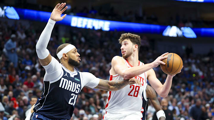 Oct 31, 2024; Dallas, Texas, USA;  Houston Rockets center Alperen Sengun (28) controls the ball as Dallas Mavericks center Daniel Gafford (21) defends during the first half at American Airlines Center. Mandatory Credit: Kevin Jairaj-Imagn Images
