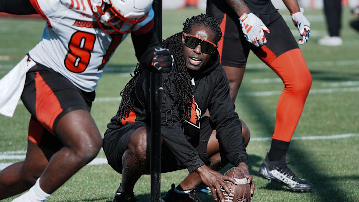 Louisville Wide Receivers Coach Deion Branch runs his squad through drills during practice outside the Trager Center in Louisville, Ky. on Mar. 1, 2025.
