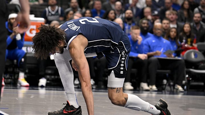 Jan 14, 2025; Dallas, Texas, USA; Dallas Mavericks center Dereck Lively II (2) reacts after suffering a possible leg injury during the first quarter against the Denver Nuggets at the American Airlines Center. Mandatory Credit: Jerome Miron-Imagn Images