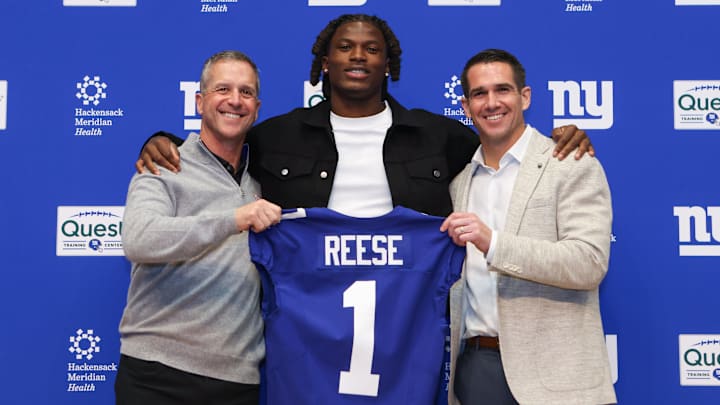 Apr 24, 2026; East Rutherford, NJ, USA; New York Giants draft pick Arvell Reese, Head Coach John Harbaugh (left) and General Manager Joe Schoen (right) pose for a photo during the introductory press conference at Quest Diagnostics Training Center.