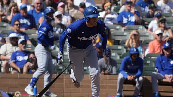 Feb 27, 2025; Salt River Pima-Maricopa, Arizona, USA; Los Angeles Dodgers first base Freddie Freeman (5) hits a single against the Colorado Rockies during the first inning at Salt River Fields at Talking Stick. Mandatory Credit: Rick Scuteri-Imagn Images