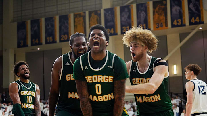 George Mason Patriots forward Jalen Haynes (11), guard K.D. Johnson (0), and guard Brayden O'Connor (4) celebrate gaining possession of the ball during the first half of the game against the Marquette Golden Eagles on Friday November 8 2024 at the Al McGuire Center in Milwaukee, Wis.