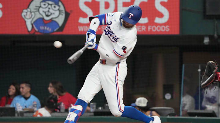 Apr 3, 2026; Arlington, Texas, USA; Texas Rangers right fielder Brandon Nimmo (24) connects for a triple against the Cincinnati Reds during the seventh inning at Globe Life Field. Mandatory Credit: Jim Cowsert-Imagn Images