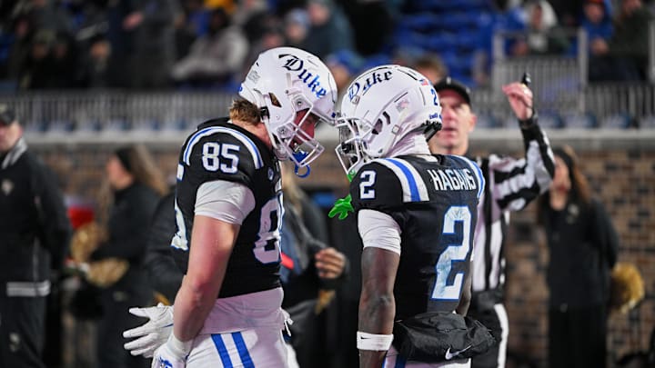 Nov 29, 2025; Durham, North Carolina, USA;   Duke Blue Devils wide receiver Sahmir Hagans (2) celebrates with tight end Jeremiah Hasley (85) after scoring a touchdown against the Wake Forest Demon Deacons during the third quarter at Wallace Wade Stadium. Mandatory Credit: Zachary Taft-Imagn Images