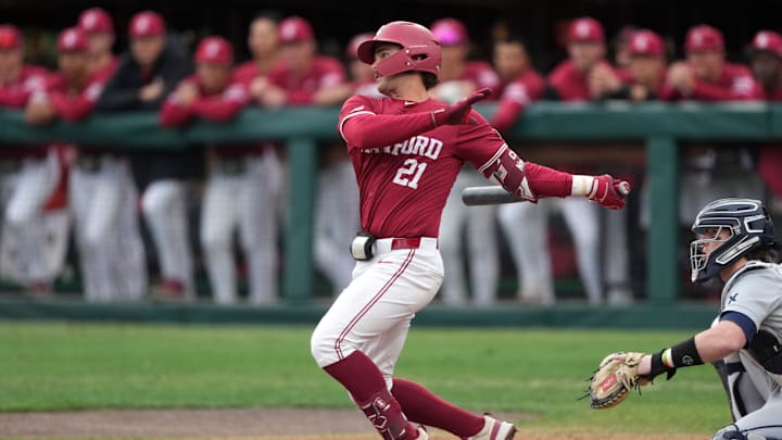 Mar 1, 2025; Stanford, CA, USA; Stanford Cardinal designated hitter Charlie Saum (21) hits a single against the Xavier Musketeers during the third inning at Sunken Diamond. Mandatory Credit: Darren Yamashita-Imagn Images