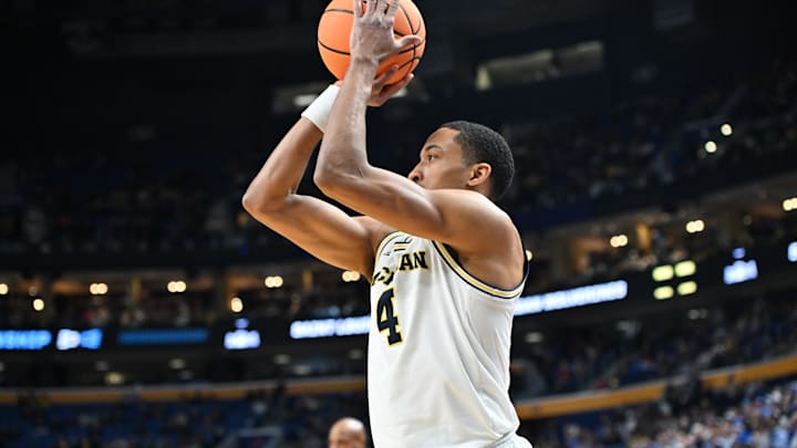 Mar 21, 2026; Buffalo, NY, USA; Michigan Wolverines guard Nimari Burnett (4) shoots in the second half against the Saint Louis Billikens during a second round game of the men's 2026 NCAA Tournament at Keybank Center. Mandatory Credit: Mark Konezny-Imagn Images