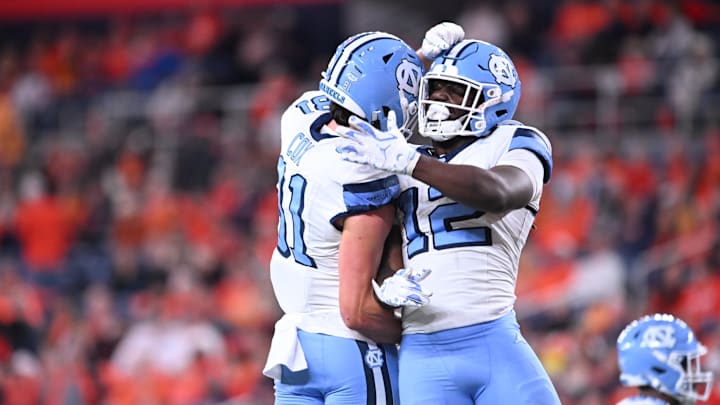 Oct 31, 2025; Syracuse, New York, USA; North Carolina Tar Heels running back Demon June (12) is greeted by tight end Conner Cox (81) after scoring a touchdown in the third quarter against the Syracuse Orange at the JMA Wireless Dome. Mandatory Credit: Mark Konezny-Imagn Images