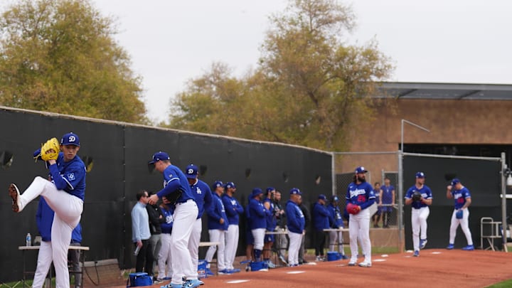 Feb 12, 2025; Glendale, AZ, USA; Los Angeles Dodgers pitcher Roki Sasaki (11) throws during a Spring Training workout at Camelback Ranch. Mandatory Credit: Joe Camporeale-Imagn Images