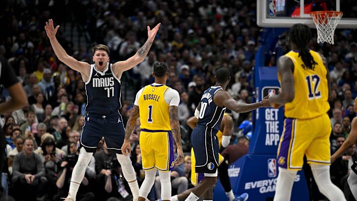 Dec 12, 2023; Dallas, Texas, USA; Dallas Mavericks guard Luka Doncic (77) reacts to a call as forward Tim Hardaway Jr. (10) and Los Angeles Lakers guard D'Angelo Russell (1) and forward Taurean Prince (12) look for the ball during the second half at the American Airlines Center. Mandatory Credit: Jerome Miron-Imagn Images