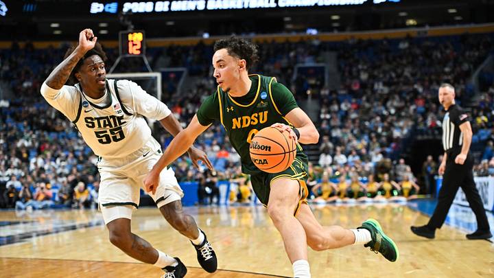 Mar 19, 2026; Buffalo, NY, USA; North Dakota State Bison guard Trevian Carson (0) drives against Michigan State Spartans forward Coen Carr (55) during the first half during a first round game of the men's 2026 NCAA Tournament at Keybank Center. Mandatory Credit: Mark Konezny-Imagn Images Mar 19, 2026; Buffalo, NY, USA; North Dakota State Bison guard Trevian Carson (0) drives against Michigan State Spartans forward Coen Carr (55) during the first half during a first round game of the men's 2026 NCAA Tournament at Keybank Center. Mandatory Credit: Mark Konezny-Imagn Images
