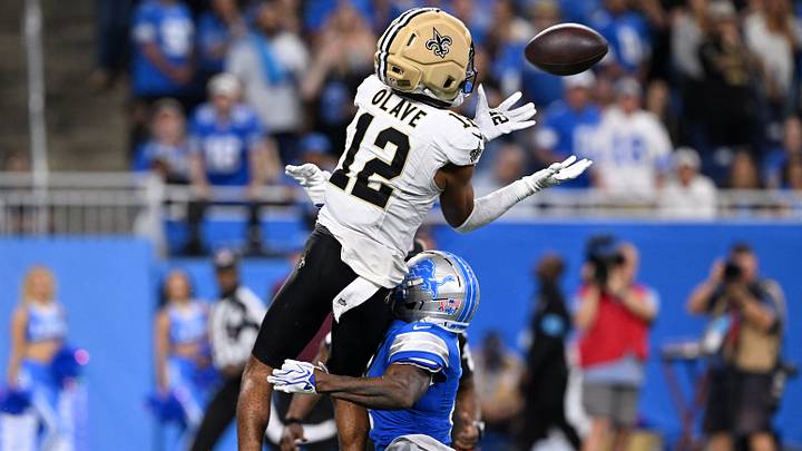 Sep 13, 2026; Detroit, Michigan, USA; New Orleans Saints wide receiver Chris Olave (12) makes a catch over Detroit Lions cornerback D.J. Reed (4) during the fourth quarter at Ford Field. Mandatory Credit: Lon Horwedel-Imagn Images Sep 13, 2026; Detroit, Michigan, USA; New Orleans Saints wide receiver Chris Olave (12) makes a catch over Detroit Lions cornerback D.J. Reed (4) during the fourth quarter at Ford Field. Mandatory Credit: Lon Horwedel-Imagn Images