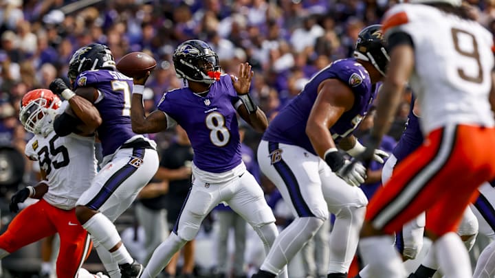 Sep 14, 2025; Baltimore, Maryland, USA; Baltimore Ravens quarterback Lamar Jackson (8) throws a touchdown pass during the fourth quarter at M&T Bank Stadium. Mandatory Credit: Peter Casey-Imagn Images
