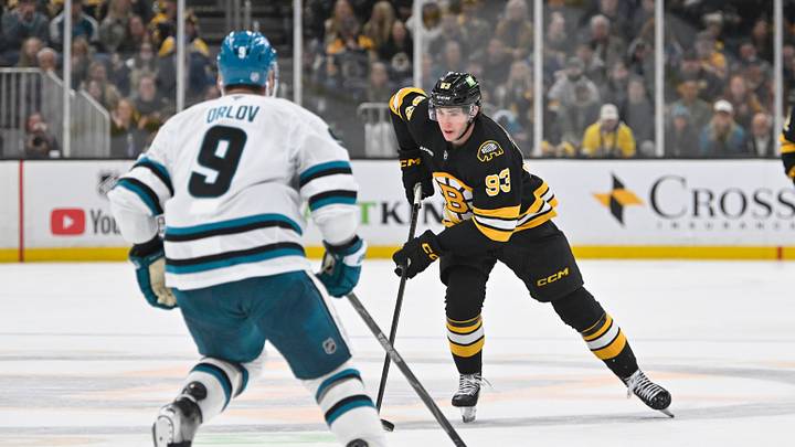 Oct 24, 2026; Boston, Massachusetts, USA; Boston Bruins center Fraser Minten (93) carries the puck through the neural zone against San Jose Sharks defenseman Dmitry Orlov (9) during the third period at TD Garden. Mandatory Credit: Eric Canha-Imagn Images Oct 24, 2026; Boston, Massachusetts, USA; Boston Bruins center Fraser Minten (93) carries the puck through the neural zone against San Jose Sharks defenseman Dmitry Orlov (9) during the third period at TD Garden. Mandatory Credit: Eric Canha-Imagn Images