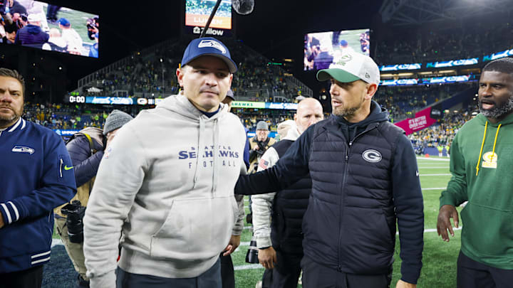 Dec 15, 2024; Seattle, Washington, USA; Seattle Seahawks head coach Mike Macdonald, left, talks with Green Bay Packers head coach Matt LaFleur following a Green Bay victory at Lumen Field. Mandatory Credit: Joe Nicholson-Imagn Images