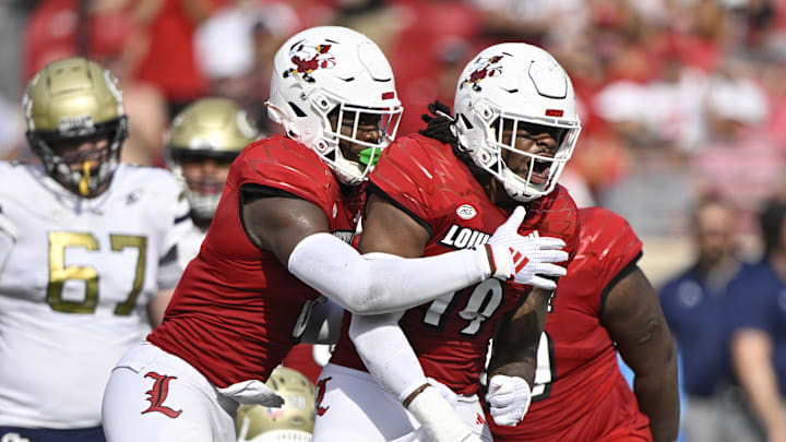 Sep 21, 2024; Louisville, Kentucky, USA;  Louisville Cardinals defensive lineman Tramel Logan (19) celebrates a defensive stop against the Georgia Tech Yellow Jackets during the first half at L&N Federal Credit Union Stadium. Mandatory Credit: Jamie Rhodes-Imagn Images