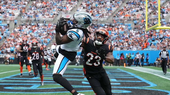 Sep 29, 2024; Charlotte, North Carolina, USA;  Carolina Panthers wide receiver Diontae Johnson (5) attempts catch as Cincinnati Bengals cornerback Dax Hill (23) defends in the first quarter at Bank of America Stadium. Mandatory Credit: Bob Donnan-Imagn Images