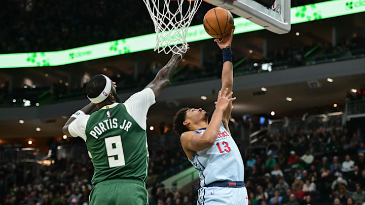 Dec 21, 2024; Milwaukee, Wisconsin, USA;  Washington Wizards guard Jordan Poole (13) shoots the ball against Milwaukee Bucks forward Bobby Portis (9) in the third quarter at Fiserv Forum. Mandatory Credit: Benny Sieu-Imagn Images