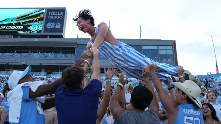 Sep 13, 2025; Chapel Hill, North Carolina, USA; North Carolina Tar Heels student Joseph Pham is tossed in the air after a touchdown in the fourth quarter at Kenan Stadium. 