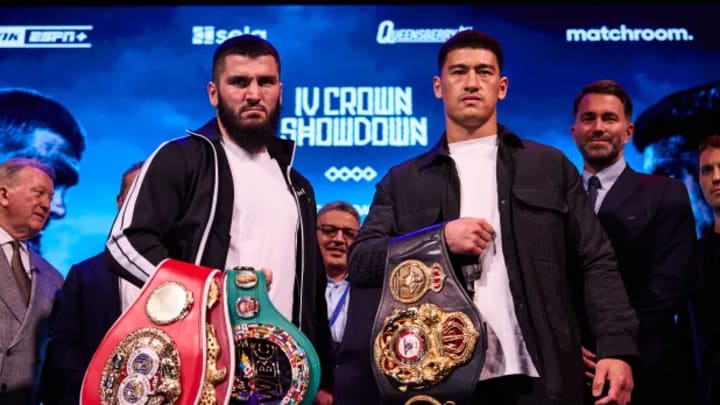 Artur Beterbiev and Dmitry Bivol showing off their titles