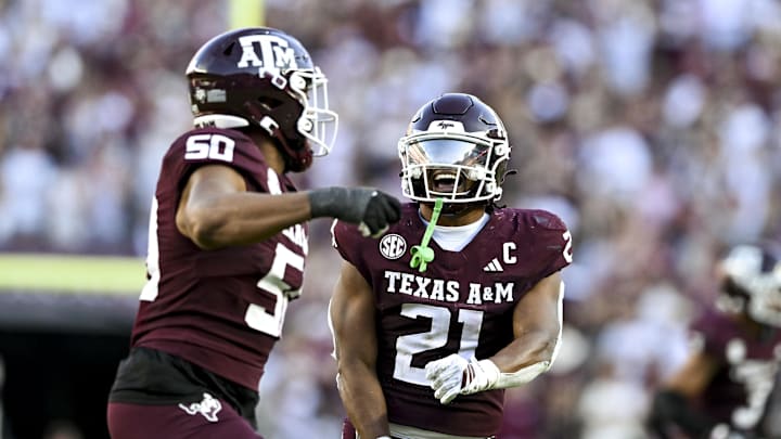 Texas A&M Aggies linebacker Taurean York (21) celebrates with defensive end Dayon Hayes (50) against the Auburn Tigers during the fourth quarter at Kyle Field. Texas A&M Aggies linebacker Taurean York (21) celebrates with defensive end Dayon Hayes (50) against the Auburn Tigers during the fourth quarter at Kyle Field.