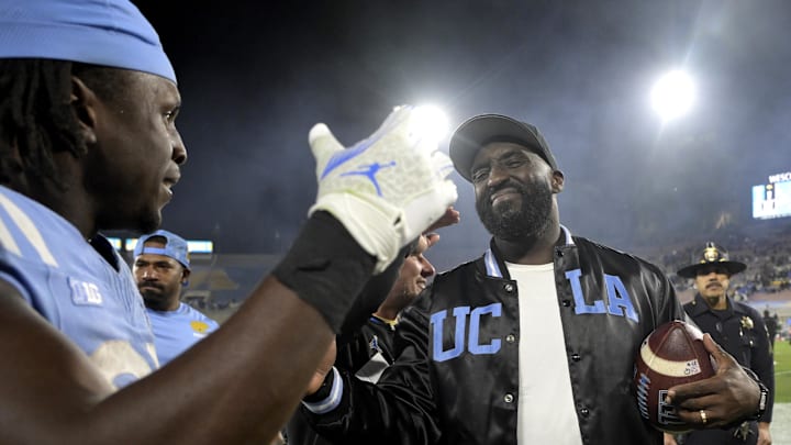 Nov 8, 2024; Pasadena, California, USA;  UCLA Bruins head coach DeShaun Foster shakes hands with running back T.J. Harden (25) after defeating the Iowa Hawkeyes at the Rose Bowl. Mandatory Credit: Jayne Kamin-Oncea-Imagn Images