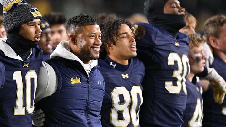 Nov 9, 2024; South Bend, Indiana, USA; Notre Dame Fighting Irish head coach Marcus Freeman stands with his players for the Notre Dame Alma Mater after defeating the Florida State Seminoles at Notre Dame Stadium. Mandatory Credit: Matt Cashore-Imagn Images