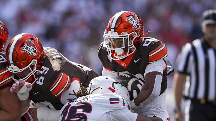 Sep 6, 2025; Cincinnati, Ohio, USA; Bowling Green Falcons running back Cameron Pettaway (26) carries the ball as he is tackled by Cincinnati Bearcats safety Xavier Williams (36) in the first half at Nippert Stadium. Mandatory Credit: Aaron Doster-Imagn Images