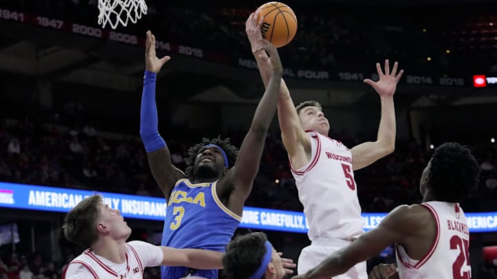 UCLA forward Eric Dailey Jr. (3) and Wisconsin guard Jack Janicki (5) vie for rebound during the first half on Tuesday, Jan. 6, 2026 at the Kohl Center in Madison.