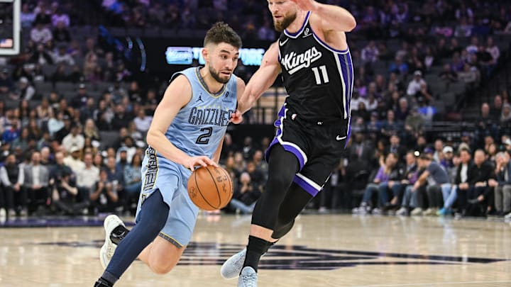 Feb 4, 2026; Sacramento, California, USA; Memphis Grizzlies guard/forward Ty Jerome (2) drives against Sacramento Kings forward/center Domantas Sabonis (11) during the second quarter at Golden 1 Center. Mandatory Credit: Ed Szczepanski-Imagn Images