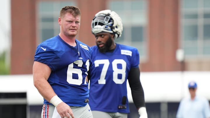 Jul 25, 2024; East Rutherford, NY, USA; New York Giants center John Michael Schmitz Jr. (61) takes a water break alongside offensive tackle Andrew Thomas (78) during training camp at Quest Diagnostics Training Center. Mandatory Credit: Lucas Boland-Imagn Images