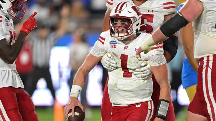 Oct 17, 2026; Pasadena, California, USA;  Wisconsin Badgers quarterback Colton Joseph (1) gets a lift after scoring a touchdown in the second half against the UCLA Bruins at the Rose Bowl. Mandatory Credit: Jayne Kamin-Oncea-Imagn Images
