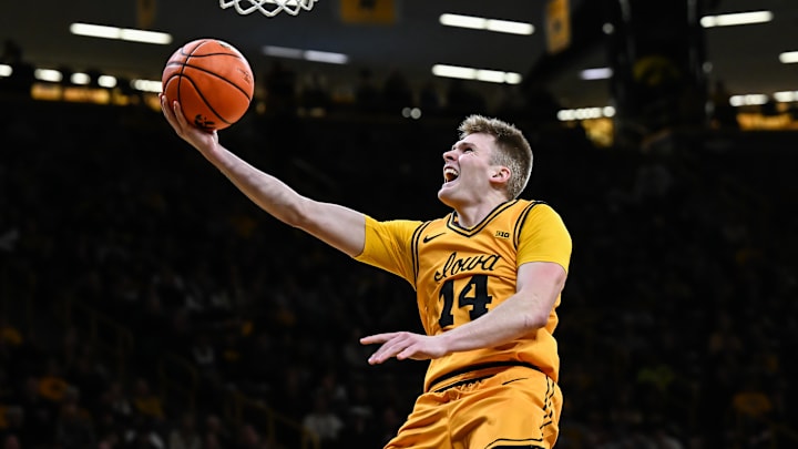 Feb 25, 2026; Iowa City, Iowa, USA; Iowa Hawkeyes guard Bennett Stirtz (14) goes to the basket against the Ohio State Buckeyes during the second half at Carver-Hawkeye Arena. Mandatory Credit: Jeffrey Becker-Imagn Images