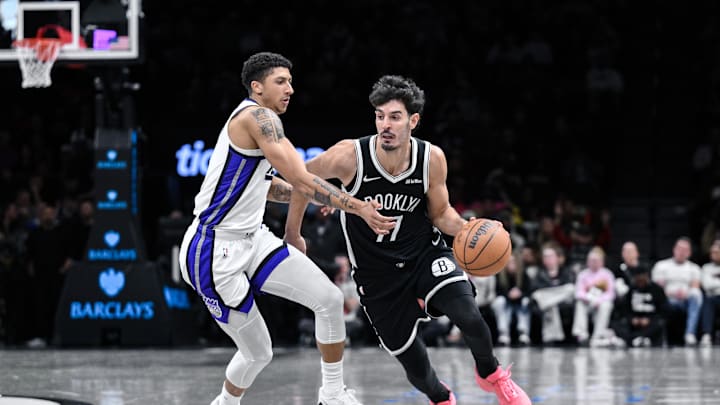 Mar 29, 2026; Brooklyn, New York, USA; Brooklyn Nets guard Ben Saraf (77) drives past Sacramento Kings guard Killian Hayes (3) during the first half at Barclays Center. Mandatory Credit: John Jones-Imagn Images