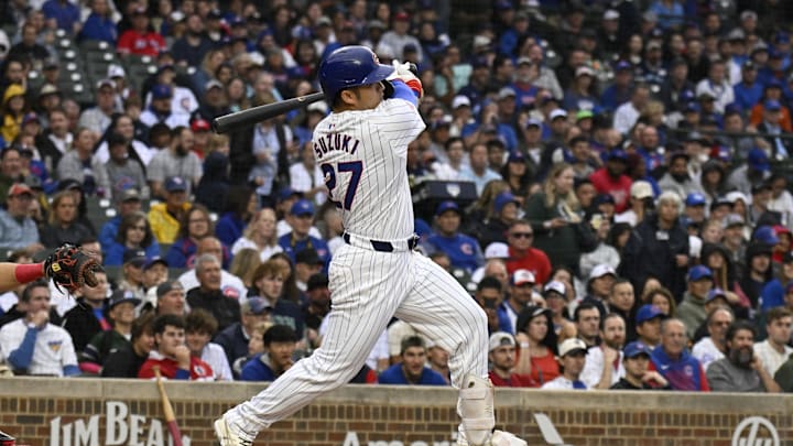 Sep 28, 2024; Chicago, Illinois, USA;  Chicago Cubs outfielder Seiya Suzuki (27) hits a single against the Cincinnati Reds during the first inning at Wrigley Field. Mandatory Credit: Matt Marton-Imagn Images