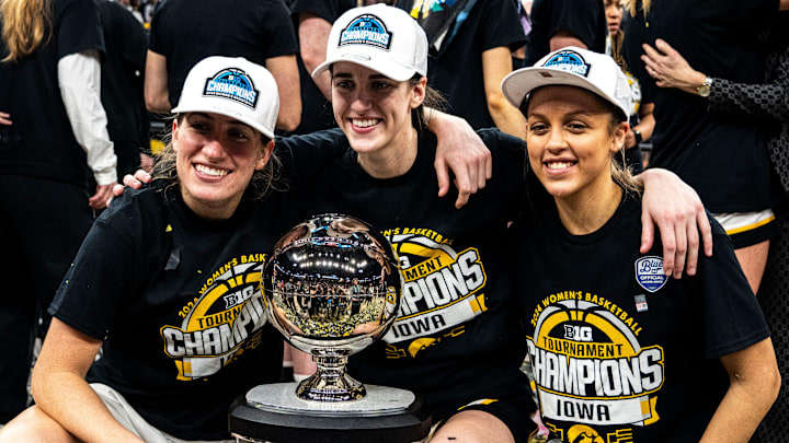 Iowa guard Kate Martin (20), Iowa guard Caitlin Clark (22) and Iowa guard Gabbie Marshall (24) pose for a photo after the Big Ten Tournament championship game at the Target Center on Sunday, March 10, 2024, in Minneapolis, Minn.