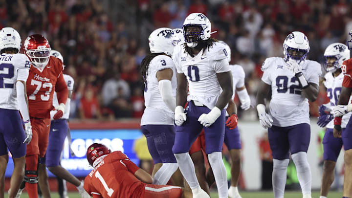 Nov 22, 2025; Houston, Texas, USA; TCU Horned Frogs defensive lineman Zachary Chapman (0) reacts after making a tackle on Houston Cougars quarterback Conner Weigman (1) during the fourth quarter at TDECU Stadium. Mandatory Credit: Troy Taormina-Imagn Images