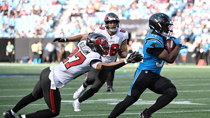 Oct 25, 2026; Charlotte, North Carolina, USA;  Carolina Panthers running back Anthony Tyus III (34) runs against Tampa Bay Buccaneers cornerback Zyon McCollum (27) during the second half at Bank of America Stadium.  Mandatory Credit: Bob Donnan-Imagn Images